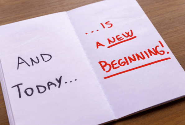 Image of open book that says 'And today is a new beginning'